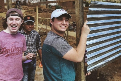 men smiling happily while participating in a mission